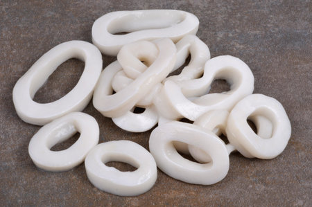 Raw squid rings on gray background