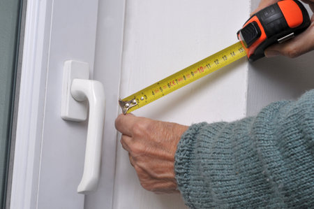 Someone taking measurements with a tape measureの写真素材