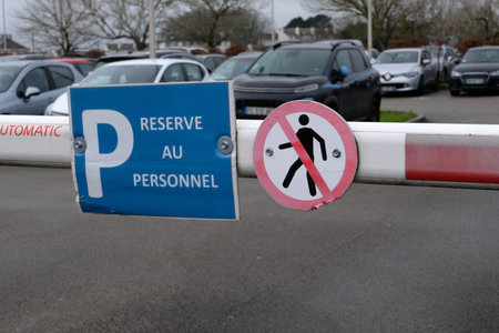 Staff parking sign with a no pedestrians sign on an automatic barrier close up