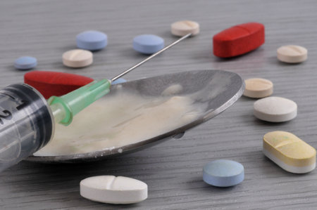 Addiction concept with various psychoactive substances and a syringeの写真素材