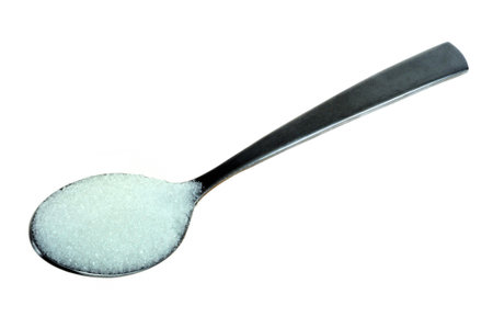 Spoon of powdered sugar close-up on white backgroundの写真素材