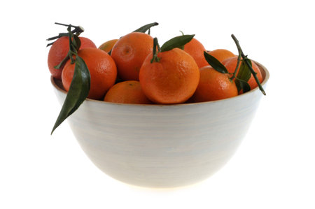 Clementine salad bowl with leaves close-up on white backgroundの写真素材