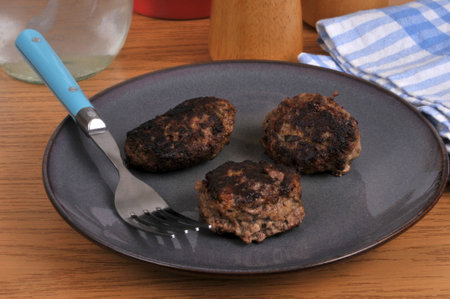 Homemade beef meatballs served on a plate with a fork