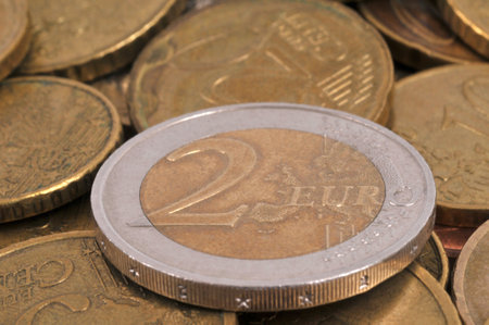 Two euro coins close-up on a background of coinsの写真素材