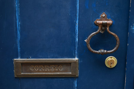 Mailbox with correio written on it inserted into a front door close-upの写真素材
