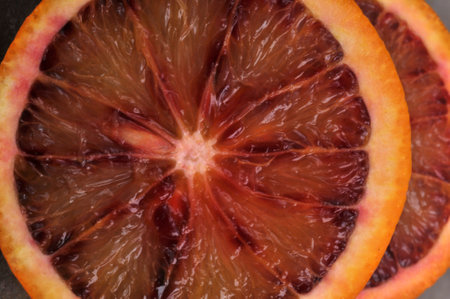 Blood orange cut in half closeup on backgroundの写真素材
