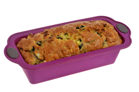 Homemade savory cake in a silicone mold closeup isolated on a white backgroundの写真素材