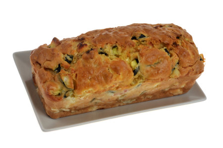 Homemade savory cake in a dish closeup isolated on a white backgroundの写真素材