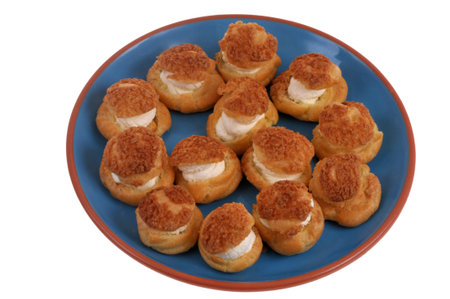 Cream puffs in a dish viewed from above on a white backgroundの写真素材