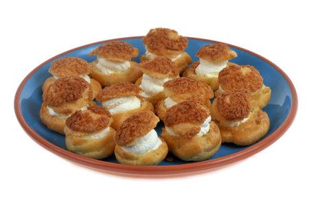 Cream puffs in a dish isolated on white backgroundの写真素材