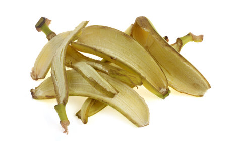 Peeled banana skins closeup isolated on white backgroundの写真素材
