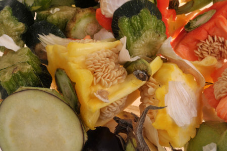 Assorted vegetable peels piled up closeup on backgroundの写真素材