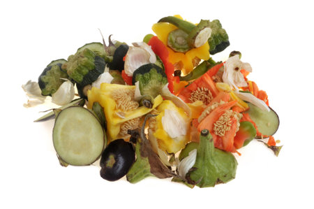 Assorted vegetable peels piled up close-up isolated on white backgroundの写真素材