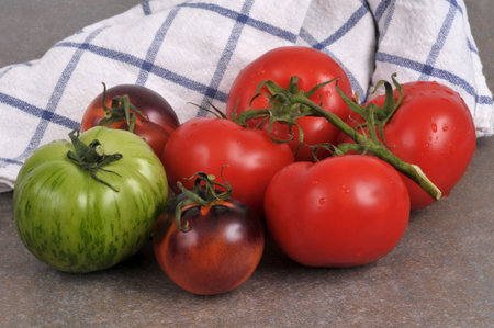 Assortment of ripe tomatoes close-upの写真素材