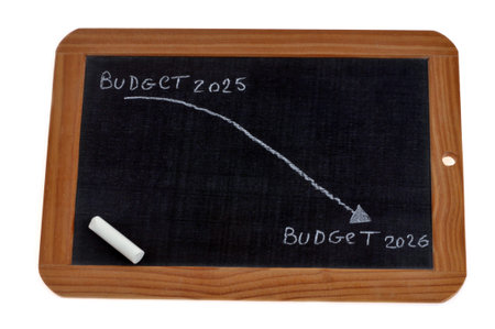 Concept of budget decrease 2026 vs 2025 with a graph on a school slateの写真素材