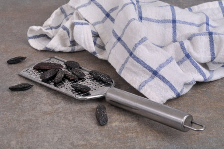 Tonka beans on a steel kitchen grater close-up