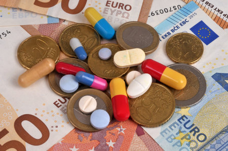 Concept of healthcare spending with medications against a background of euro banknotes and coinsの写真素材