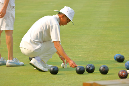 A player measures to determine which ball is closest to the Jack during competition at the West Point Grey Lawn Bowling Club in Vancouver, British Columbia on August 3,2017.のeditorial素材