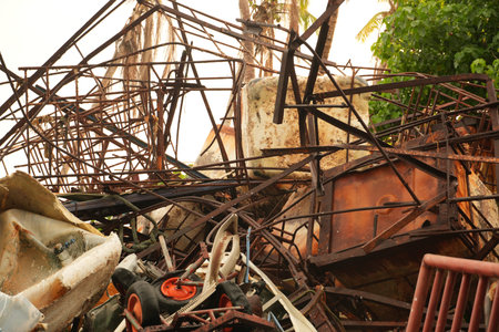 Detailed view of a collapsed and rusted building structure, showcasing environmental damage and...