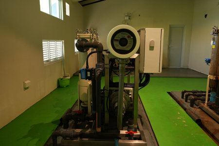 A comprehensive industrial water purification system occupies a brightly lit room with a green...