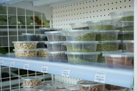 Clear containers with various grains and seeds neatly labeled and stored on shelves