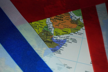 A detailed map of the Middle East is visible through a gap between national flags.