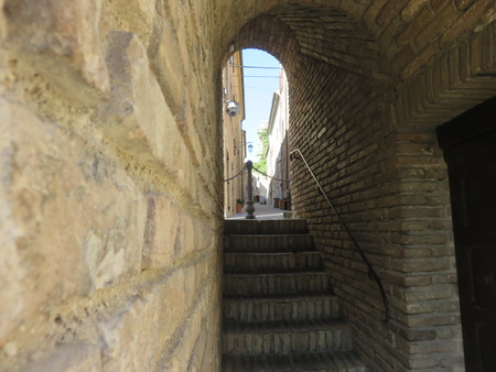 An alley with the stairs in a buildingの写真素材