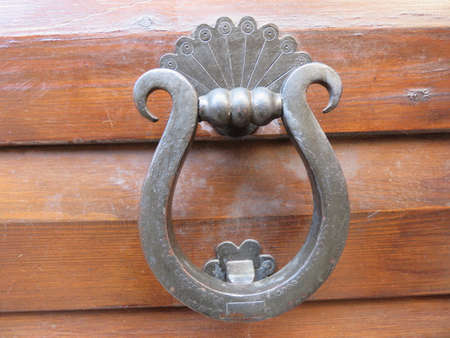 An antique door knocker in the shape of a horseshoe beautiful antique in ironの写真素材