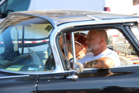 People vintage, Senigallia, Italy 12 August 2019 is an international music festival focused on American music and culture of the 1950s. In the photo: parade of vintage cars and people dressed in vintaのeditorial素材