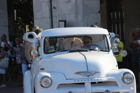 People vintage, Senigallia, Italy 12 August 2019 is a festival focused on American music and culture of the 1950s In the photo: parade of vintage cars and people dressed in vintage 1950s styleのeditorial素材