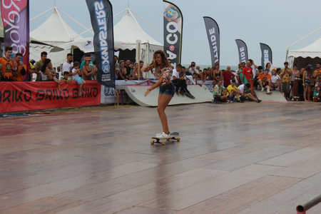 Senigallia, Marche, Italy, July 25, 2021 fantastic evolutions by these sportsmen without distinction of sex using a longer skateboard Evolutions on the Longboardのeditorial素材