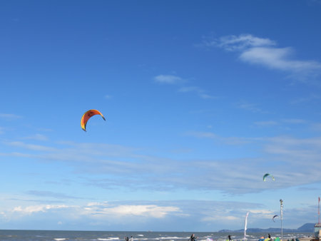 Paraglider in the blue sky. Kitesurfing on the beach.の写真素材