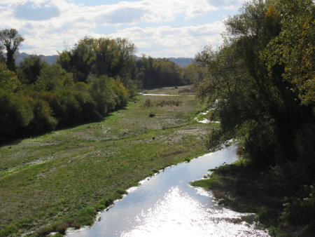 River in the meadow on a sunny autumn day. View from above.の写真素材