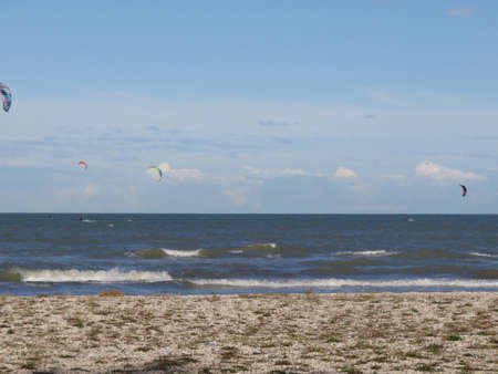 An adrenaline sport just a board a kite the sea and the wind that makes you fly over the waterの写真素材