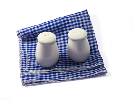 Saltcellar and pepperbox on blue and white napkinの写真素材