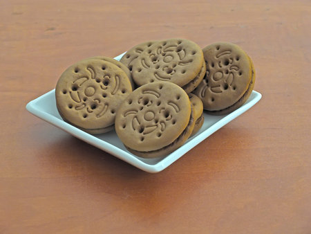 Chocolate cookies sandwiches on a white saucer