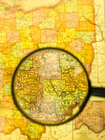 Close-up image of handheld magnifying glass on the mapの写真素材