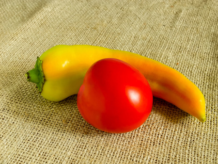 Tomato and paprika on sackcloth background.の写真素材