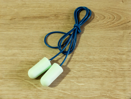 Ear plugs with cord on wooden backgroundの写真素材