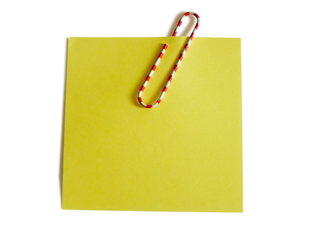 Yellow note with color paper clip isolated on white backgroundの写真素材