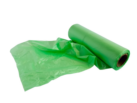 Roll of green plastic garbage bags isolated on white backgroundの写真素材