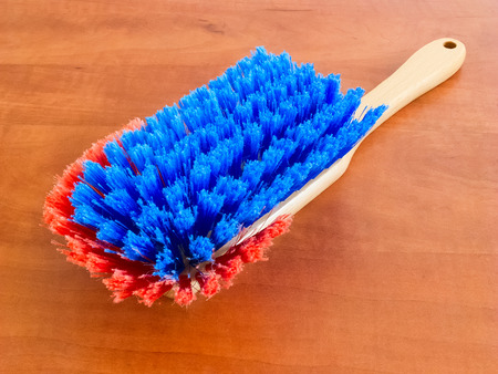 Cleaning dust brush against a wooden backgroundの写真素材