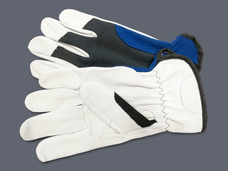 Pair of new work gloves isolated on a gray background