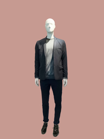 Full-length male mannequin dressed in suit over brown background. No brand names or copyright objects.の写真素材
