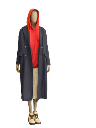 Full-length female mannequin dressed in coat, jacket with hood and skirt over white background No brand names or copyright objects.の写真素材