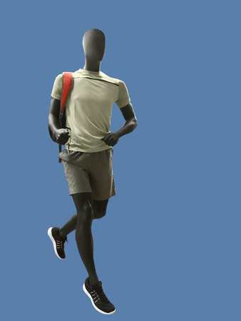 Running male mannequin isolated on blue background. No brand names or copyright objects.の写真素材
