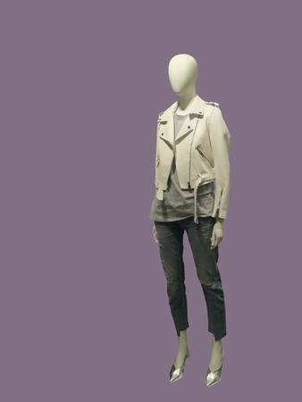 Full-length female mannequin wearing leather jacket and destroyed jeans, isolated. No brand names or copyright objects.の写真素材