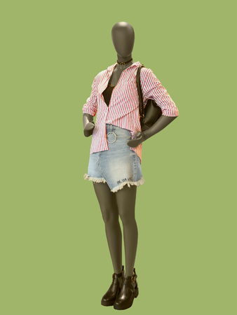 Full-length female mannequin dressed in fashionable clothes.  Isolated on green background. No brand names or copyright objects.の写真素材