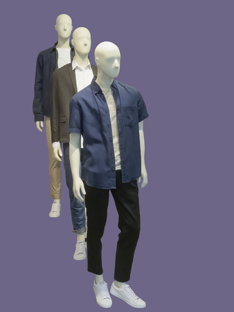 Full-length three man mannequins dressed in casual clothes, isolated. No brand names or copyright objects.の写真素材