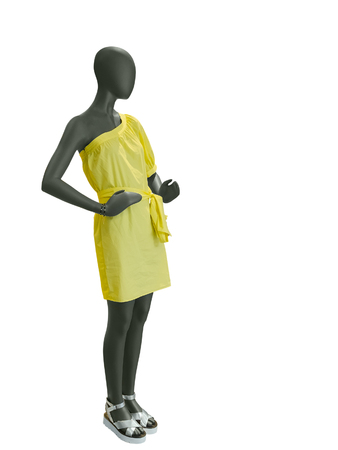 Full-length female mannequin dressed in yellow dress isolated on white background. No brand names or copyright objects.の写真素材